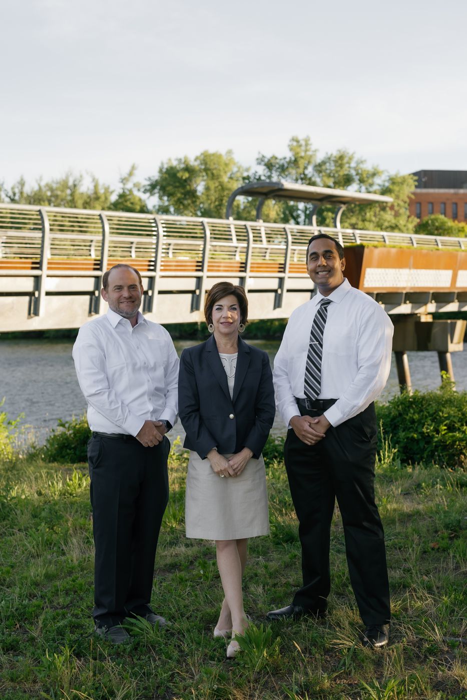 Avi Berliner, Sharon Kolb, and Amrit Ramjattan standing together at the Teaneck riverfront